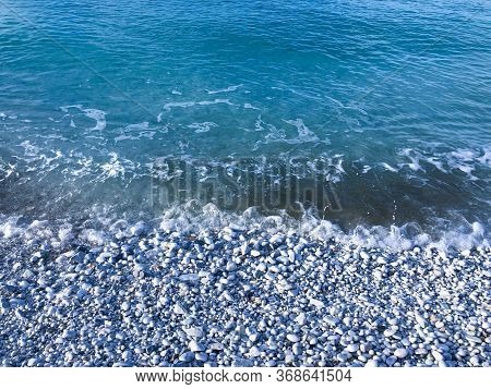 The Sea Wave With The White Pebble. Blue Ocean Background. Travel Concept. Summer Mockup. Copy Space