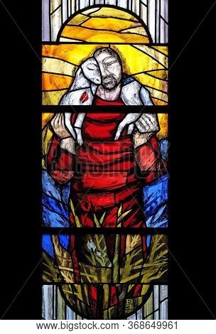 URSBERG, GERMANY - JUNE 09, 2015: Jesus the Good Shepherd, stained glass window by Sieger Koder in Chapel at cemetery in Ursberg, Germany