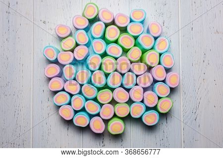 Cylinder Marshmallows Grouped On A White Wooden Backgroup Top View