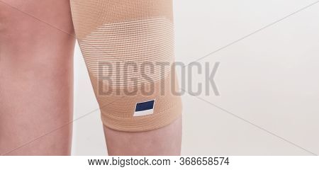 Elastic Bandage On Knee, Knee Support For Prevent Healing Injury. Injured Leg In Orthopedic Bandage