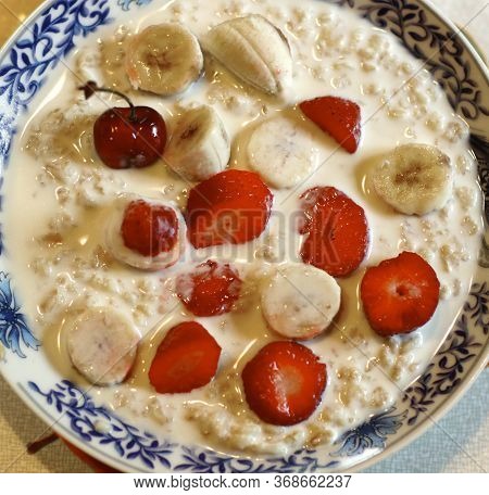 Healthy Breakfast - Porridge With Fruit Strawberry, Banana And Cherry