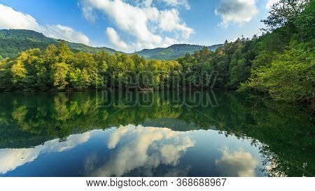 Nature At It\'s Best - Mirror-like Reflection On A Lake In Springtime