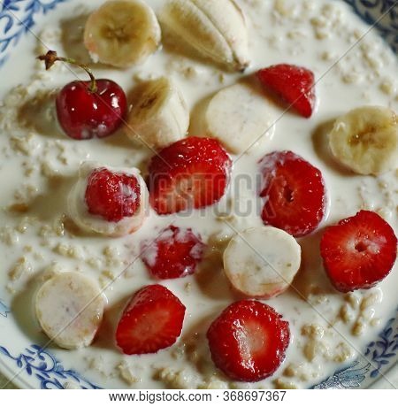Healthy Breakfast - Porridge With Fruit Strawberry, Banana And Cherry