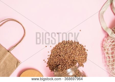 Krupa Buckwheat In A Glass Jar, Eco Package, Car For Purchases On A Pink Background.