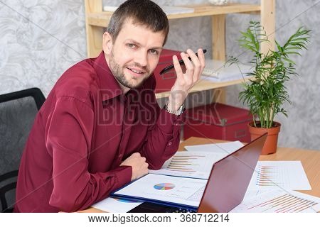 Man In The Office Listens To Voicemail On Mobile Phone
