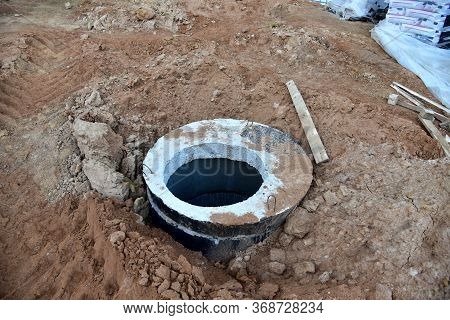 Installation Of Concrete Sewer Wells In The Ground At The Construction Site. The Use Of Reinforced C