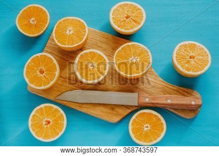 Oranges, Orange Juice And Slices Of Fruit In Blue Background