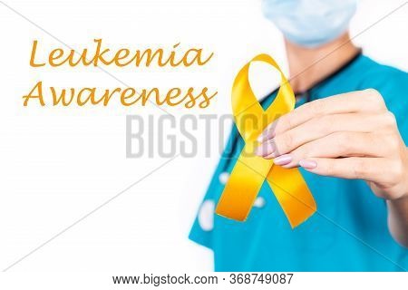 Hand Hold Orange Ribbon A Symbol Of Leukemia