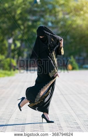 Oriental Woman In High Heel Shoes. An Islamic Woman In National Dress Wore High-heeled Shoes.