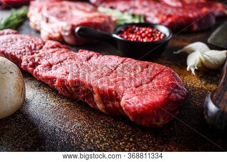 Side View Close Up Denver Steak, Flank Steak, Cut Near Denver Alternative Beef Steak And A Cleaver B