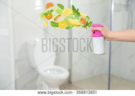 Woman Spraying Air Freshener In Bathroom, Closeup. Citrusy And Minty Aroma
