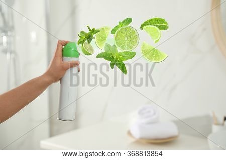 Woman Spraying Air Freshener In Bathroom, Closeup. Lime And Minty Aroma