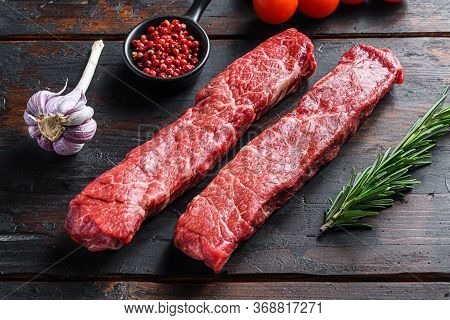 Raw Denver Steak Or Organic Top Blade Wuth Herbs On Old Wooden Planks Surface Side View