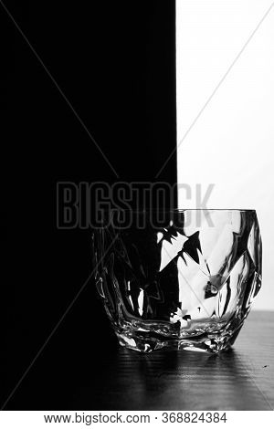 One Glass Of Whiskey On A Black White Background. Silhouette Photo