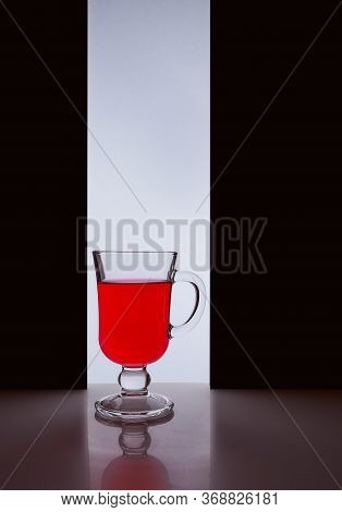 Red Glass With Red Liquid On A Black White Background. Stylish Photo