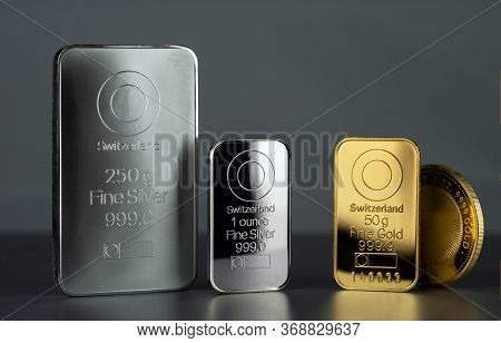 Silver And Gold Bars And Coin On A Dark Background.