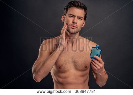 Handsome Young Bearded Man Isolated. Portrait Of Shirtless Muscular Man Is Standing On Grey Backgrou