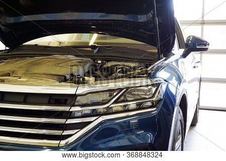 Modern Luxury Car With An Open Hood In The Service Station. In The Photo The Front Of The Car, Close