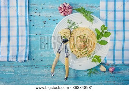 Beautifully-servered, Turquoise Wooden Table, On Which There Is A Plate With Italian Pasta With Chic