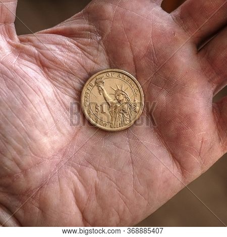 American Us Coin 1 Dollar Buck Lie On A Dirty Palm Close Up. An Impressive, Dramatic Square Shot Wit