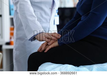 Woman Sitting On Clinic, Doctor Reassuring Patient. Doctor Helps Elderly Woman To Resist During Illn