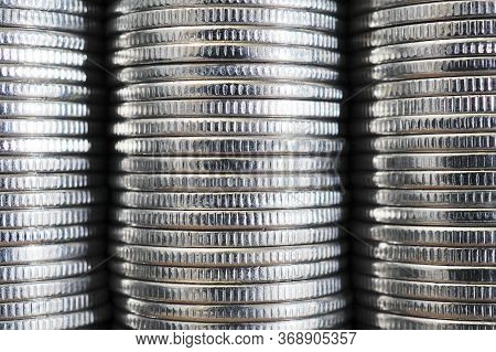 Background From Stacks And Edges Of Nickel White Coins Close-up. Textured Backdrop Or Wallpaper. 1 R
