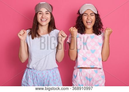 Indoor Image Of Charismatic Lovely Two Friends Having Delighted Facial Expression, Being In High Spi