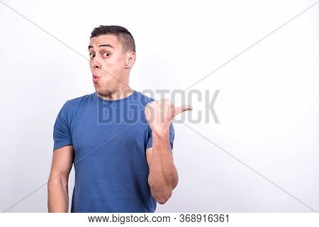 Surprised Man Pointing To Copy Space