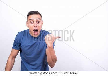 Surprised Man Pointing To Copy Space