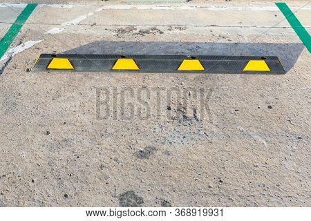 Empty Car Park Lot With Black-yellow Rubber Wheel Stopper. Parking Lot Is Divided For Making A Slot 