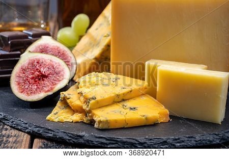 British Matured Yellow Cheese Blue Shropshire, Smoked Cheddar And Fresh Figs Close Up