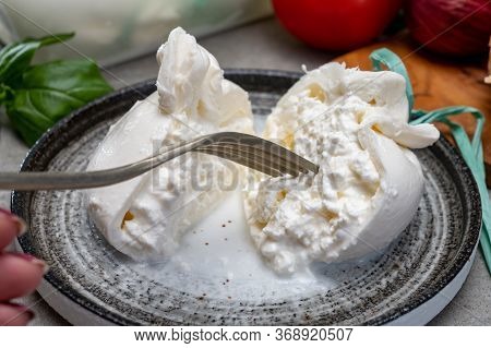 Eating Of Fresh Handmade Soft Italian Cheese From Puglia, White Balls Of Burrata Or Burratina Cheese