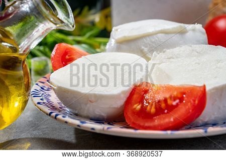 Making Of Fresh Caprese Salad With Soft Italian Cheese From Campania Buffalo Mozzarella With Tomatoe