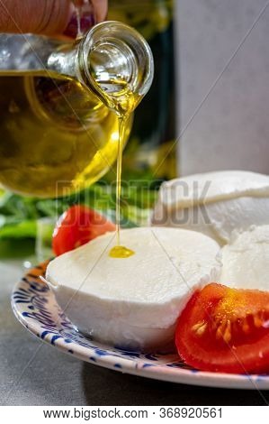 Making Of Fresh Caprese Salad With Soft Italian Cheese From Campania Buffalo Mozzarella With Tomatoe
