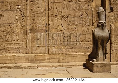 Hieroglyphic Wall And Mythological Hawk Sculpture Carved By The Ancient Egyptians In The Edfu Temple