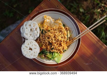 Instant Noodles Served With Vegetables, Chili And Crackers