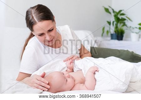 Mother Love. Caucasian Young Brunette Woman Mom Looking To Her Little Cutest Baby Lying In Bed. Infa