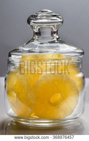 Dried Pineapple Candy Rings, In Powdered Sugar, Close-up Under Sunlight, Lying In A Transparent Glas