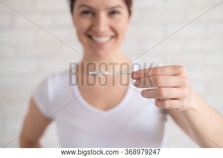Happy Woman Shows A Positive Ovulation Test. The Concept Of Female Fertility And High Luteinizing Ho