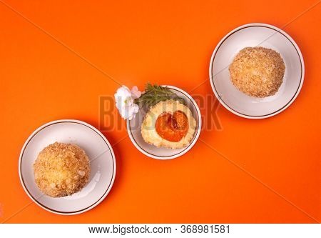 Austrian And Czech Sweet Dessert Apricot Dumplings On Orange Background. Filled Cottage Cheese Dough