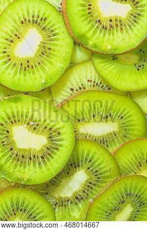 Close-up Fresh Slices Of Juicy Kiwi Fruit On White Background. Slices Of Kiwi Fruit In Sparkling Wat