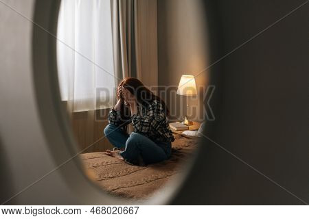 Reflection On Mirror Of Desperate Young Woman Crying Suffering From Depression Sitting On Bed In Bed