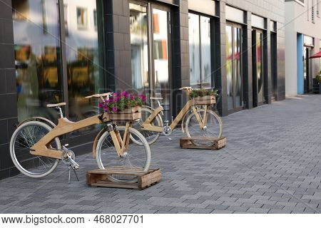 Bikes With Beautiful Flowers Near Building On City Street