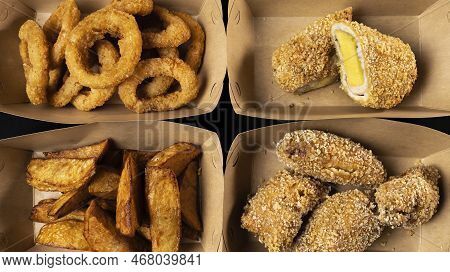 Top View Of Four Boxes Of Fried Fast Food, Chicken Nuggets, Fried Onion And Cheese, Backed Potato