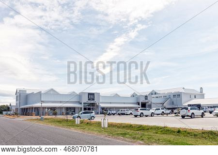 Struisbaai, South Africa - Sep 22, 2022: A Street Scene, With A Builders Supply Store And Vehicles, 