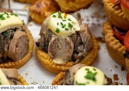 French Mini Quiche Pie With Goat Cheese And Traditional French Sausage Andouillette From Troyes In B