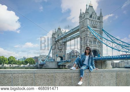 Asian Women On City Trip In London By The River Thames At The Famous Places In London, Tower Bridge