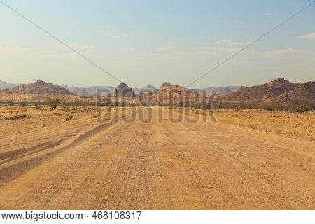 Namibian Landscape Along The Gravel Road. Yellow Ground And African Vegetation Around. Damaraland, H
