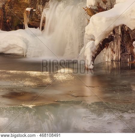 Frozen Waterfall. Mountain Water Cascades Covered With Ice