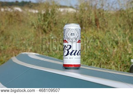 Sumy, Ukraine - August 01, 2021: Can Of Budweiser Lager Alcohol Beer On Overturned Kayak Boat Outdoo